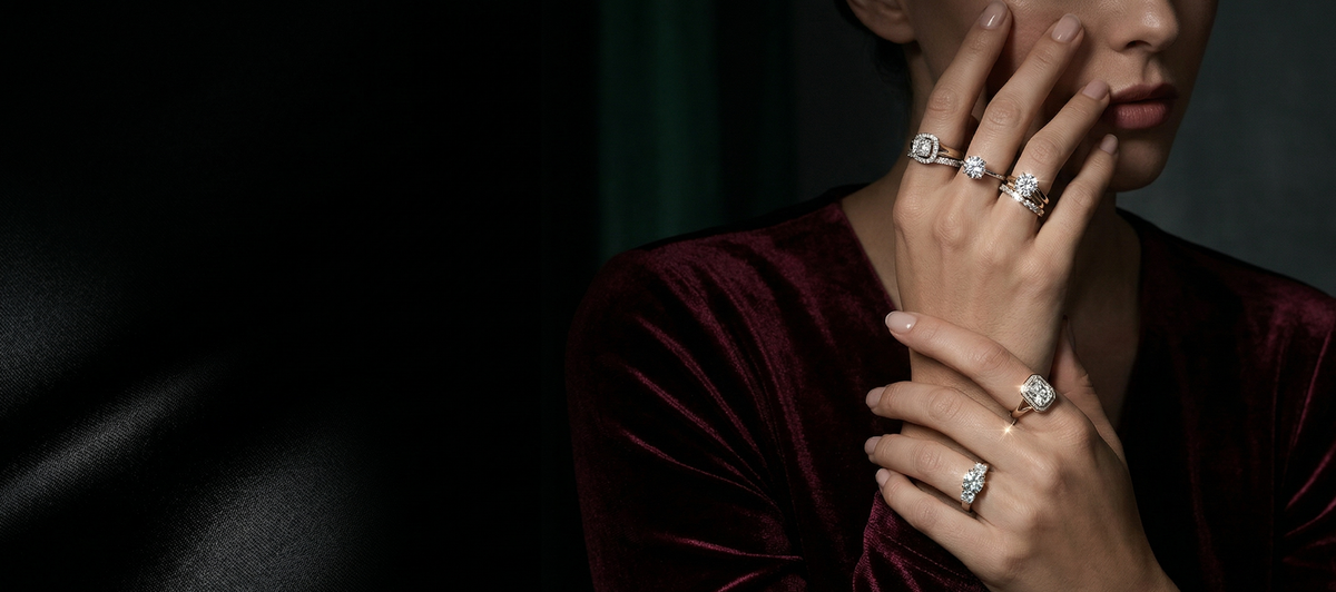 Person wearing multiple rings on dark background